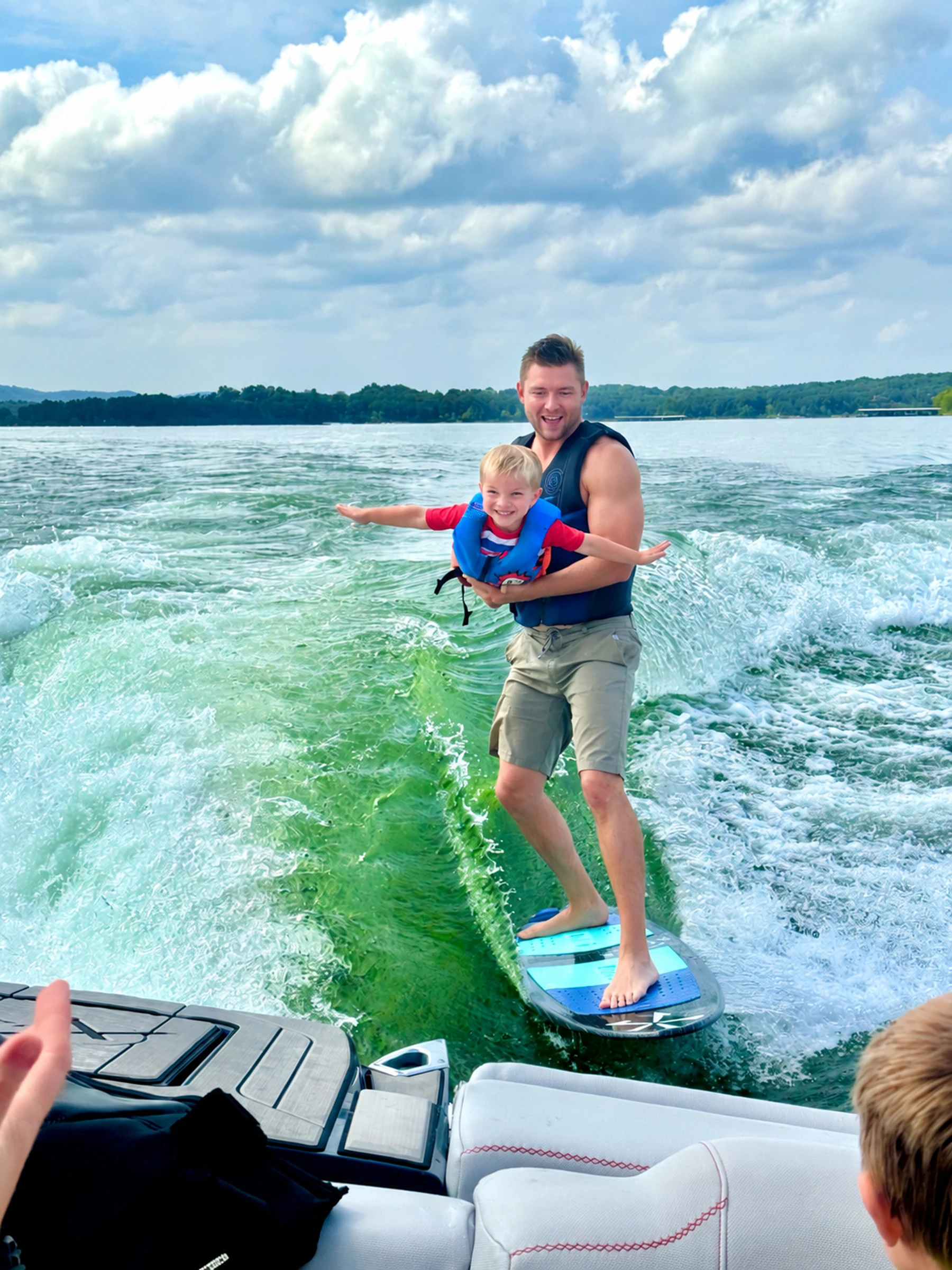 Dane wakesurfing with his son